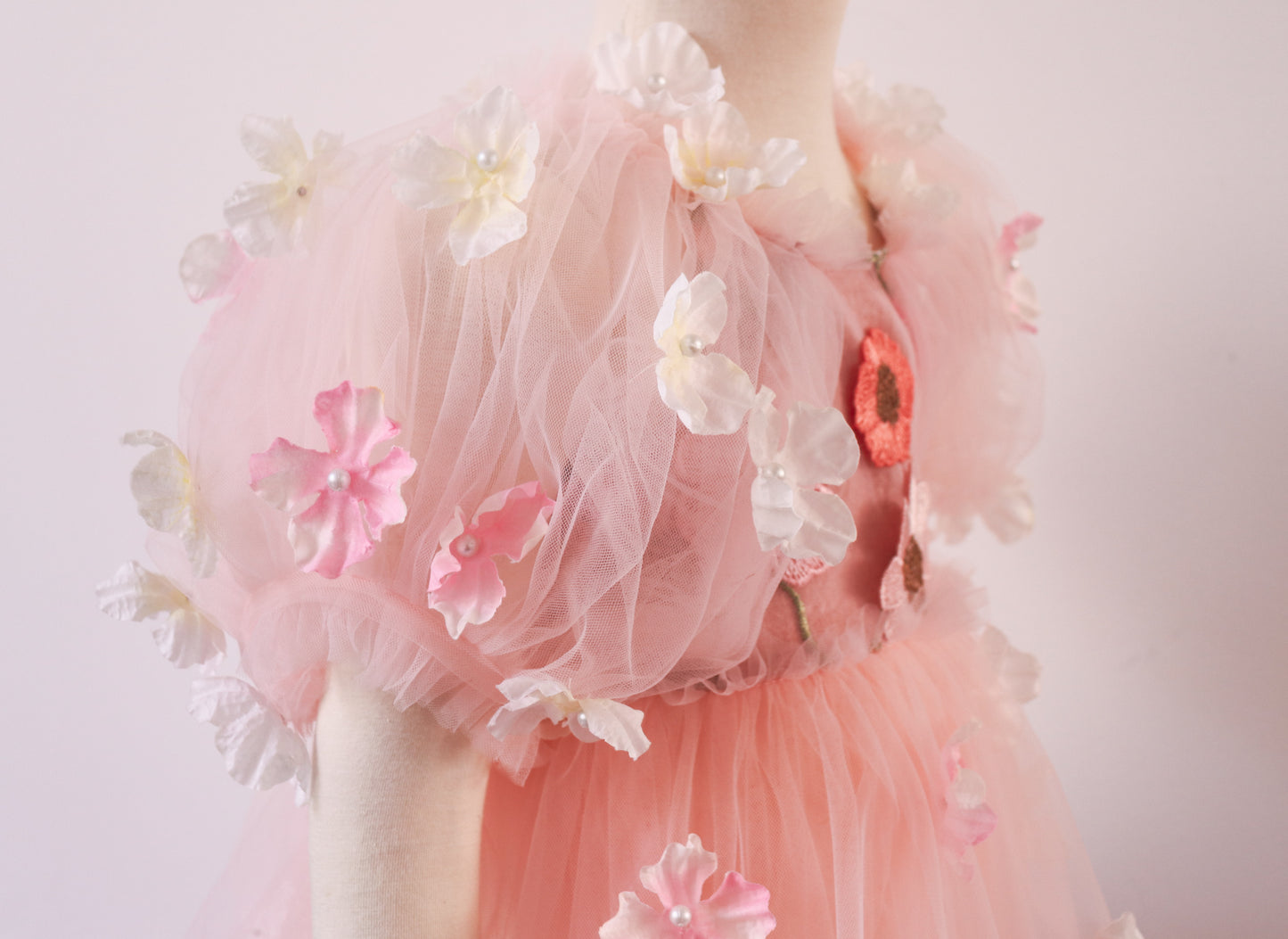 Romantic Pink Tulle Dress with Embroidery & Puffy Sleeves
A flowing tulle skirt with scattered 3D petals, creating a dreamy, fairytale-inspired look.