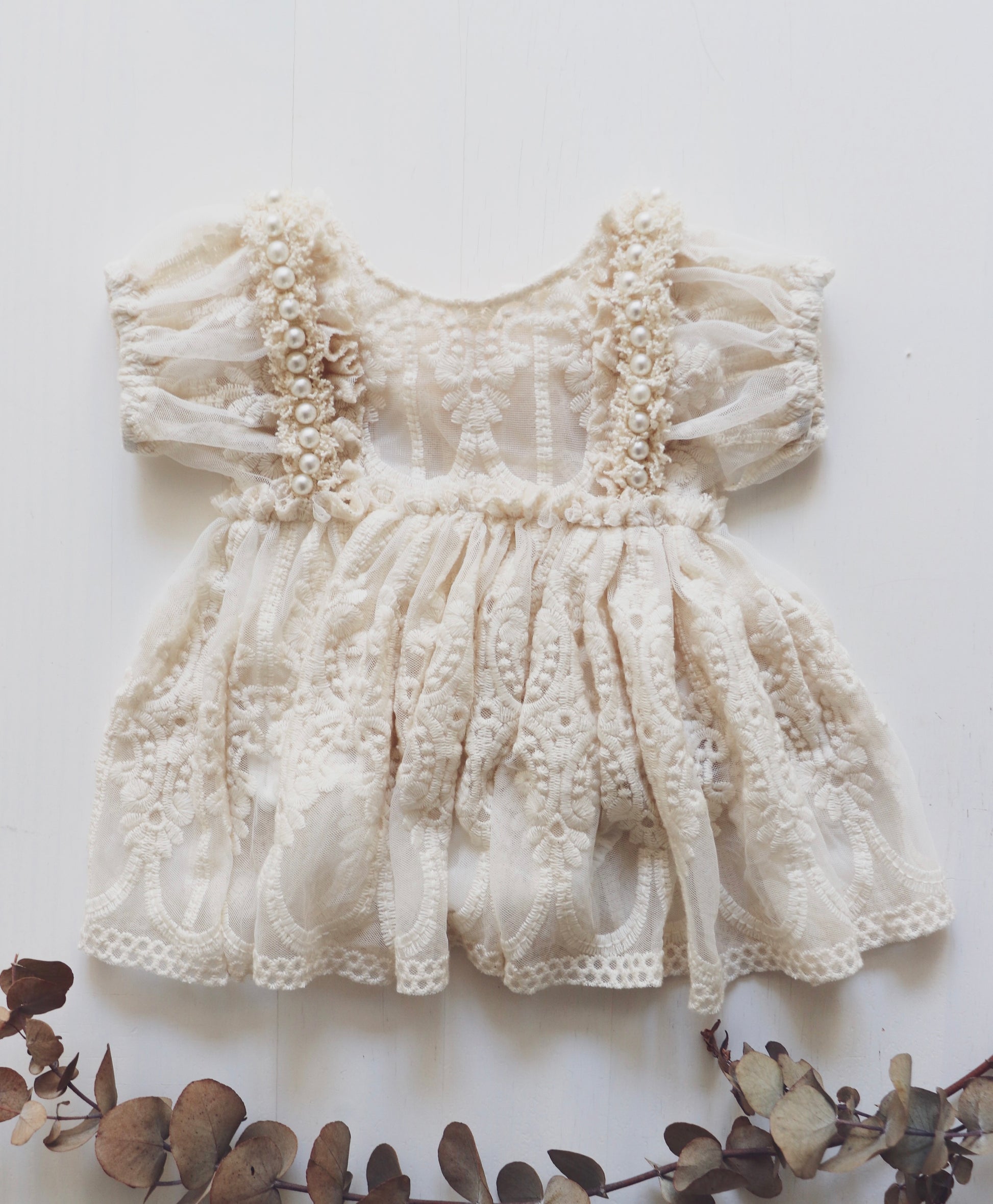 Boho-inspired newborn romper dress with light beige tulle, vintage embroidery lace, and puff sleeves, ideal for special occasions