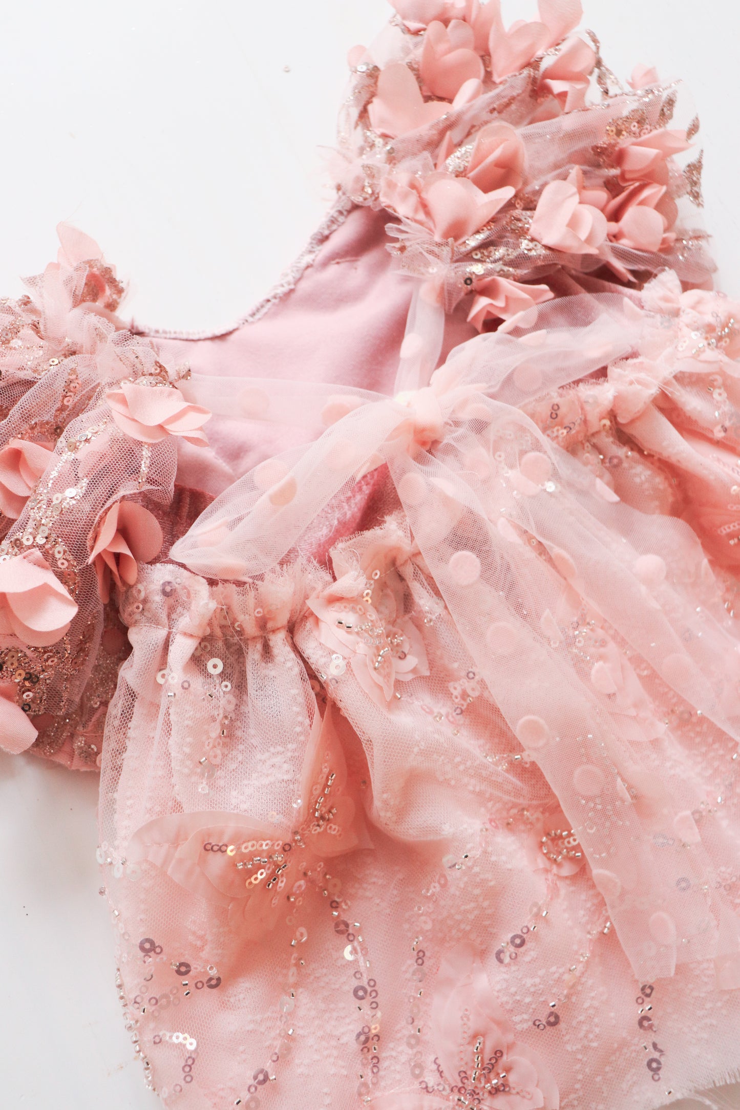 Whimsical girl’s pink dress with 3D flower petals and glitter on the bodice