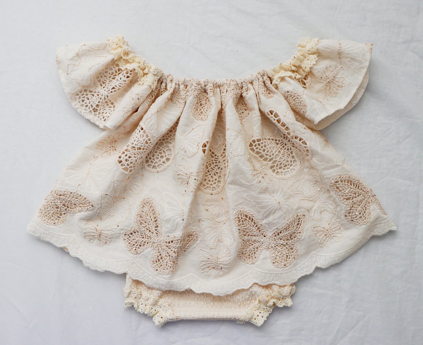 Beige cotton knit baby bloomer set with butterfly embroidery and ruffled sleeves by FLEUR MARGOT