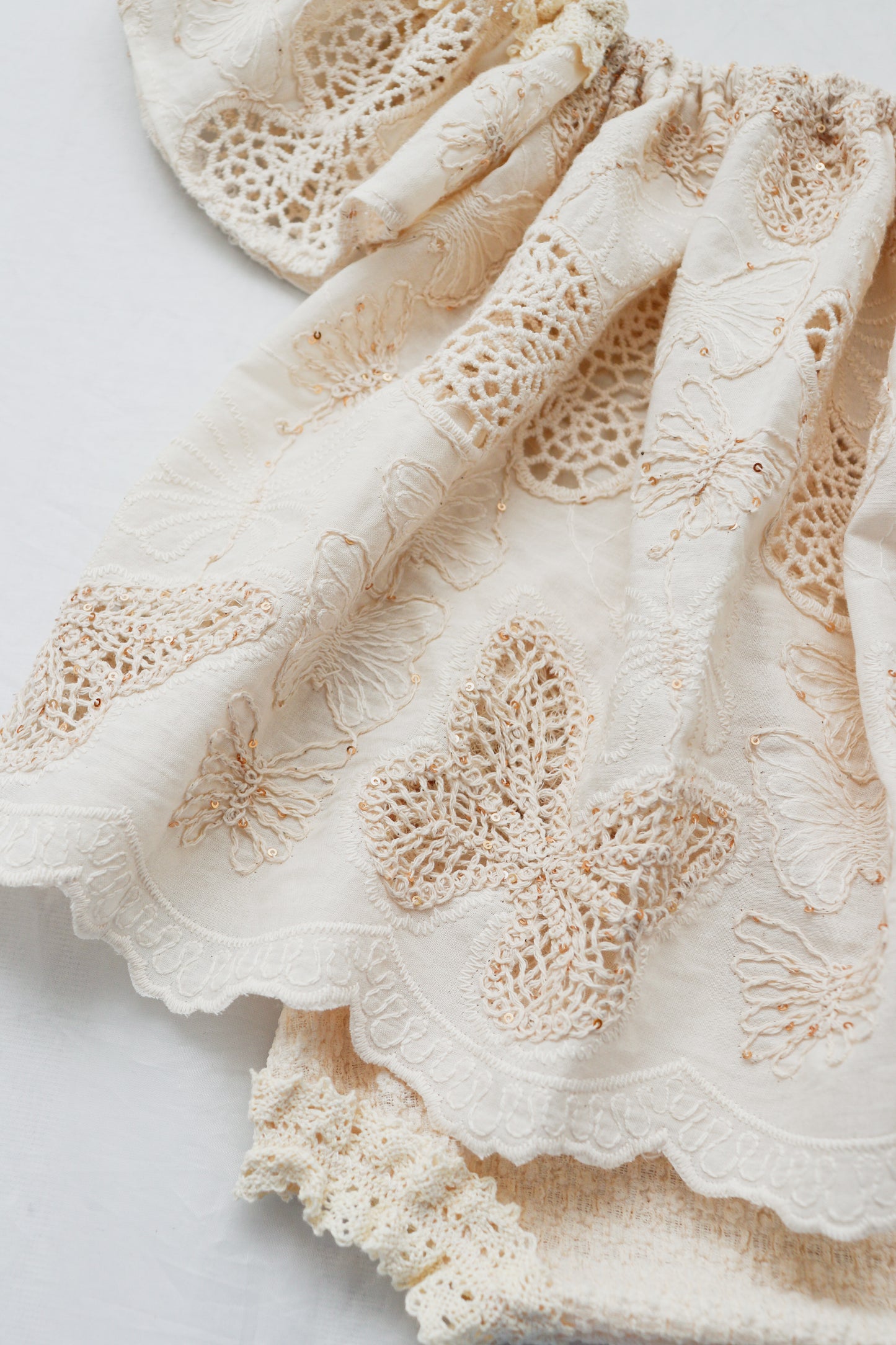 Beige cotton knit baby bloomer set with delicate butterfly embroidery and scalloped edges