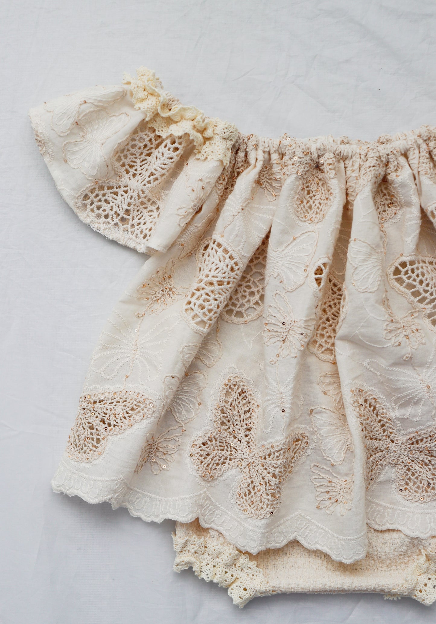 Beige cotton knit baby bloomer set with butterfly lace design and ruffled edges by FLEUR MARGOT