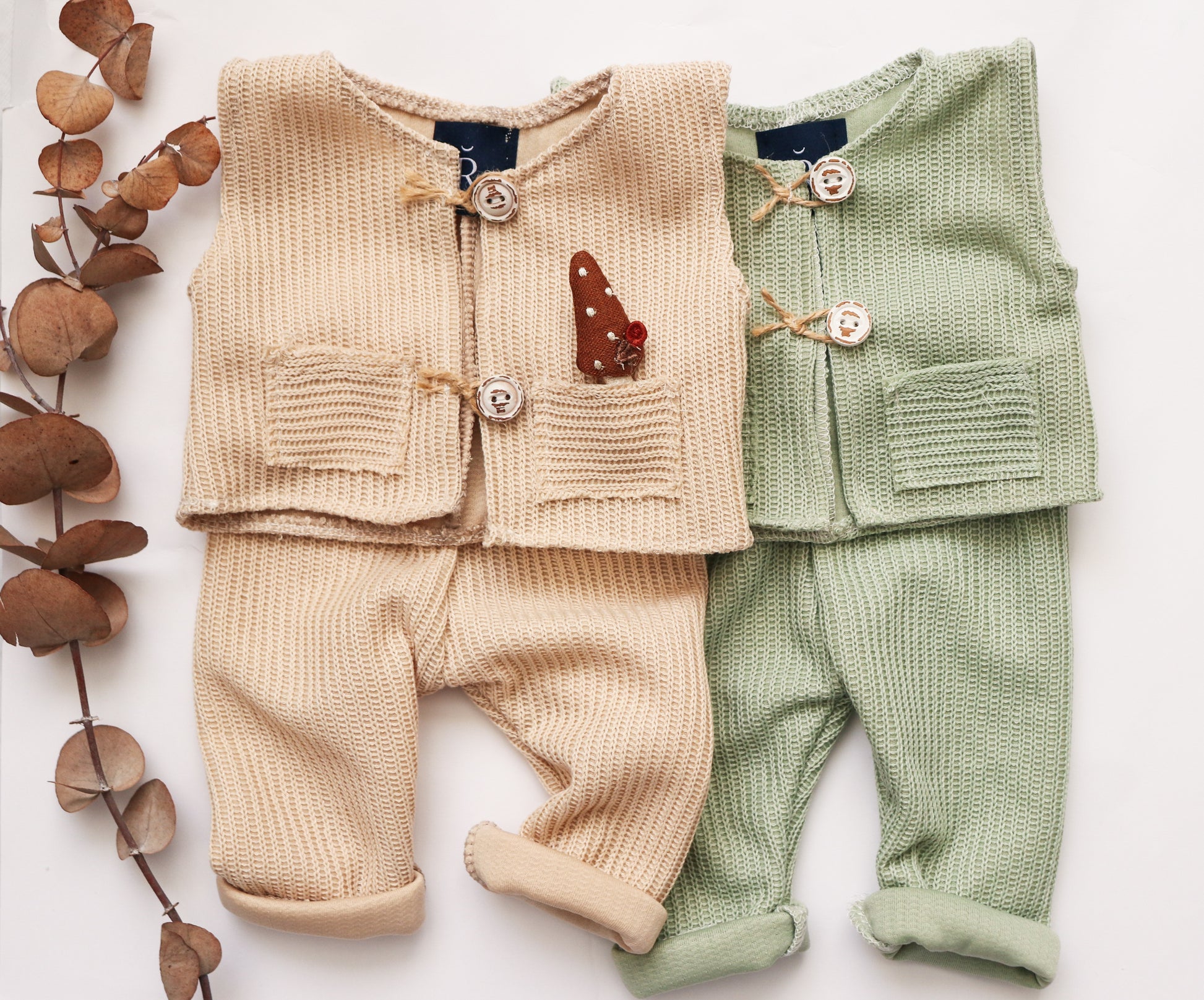 Beige newborn photo session outfit featuring a knitted vest with button details and matching pants