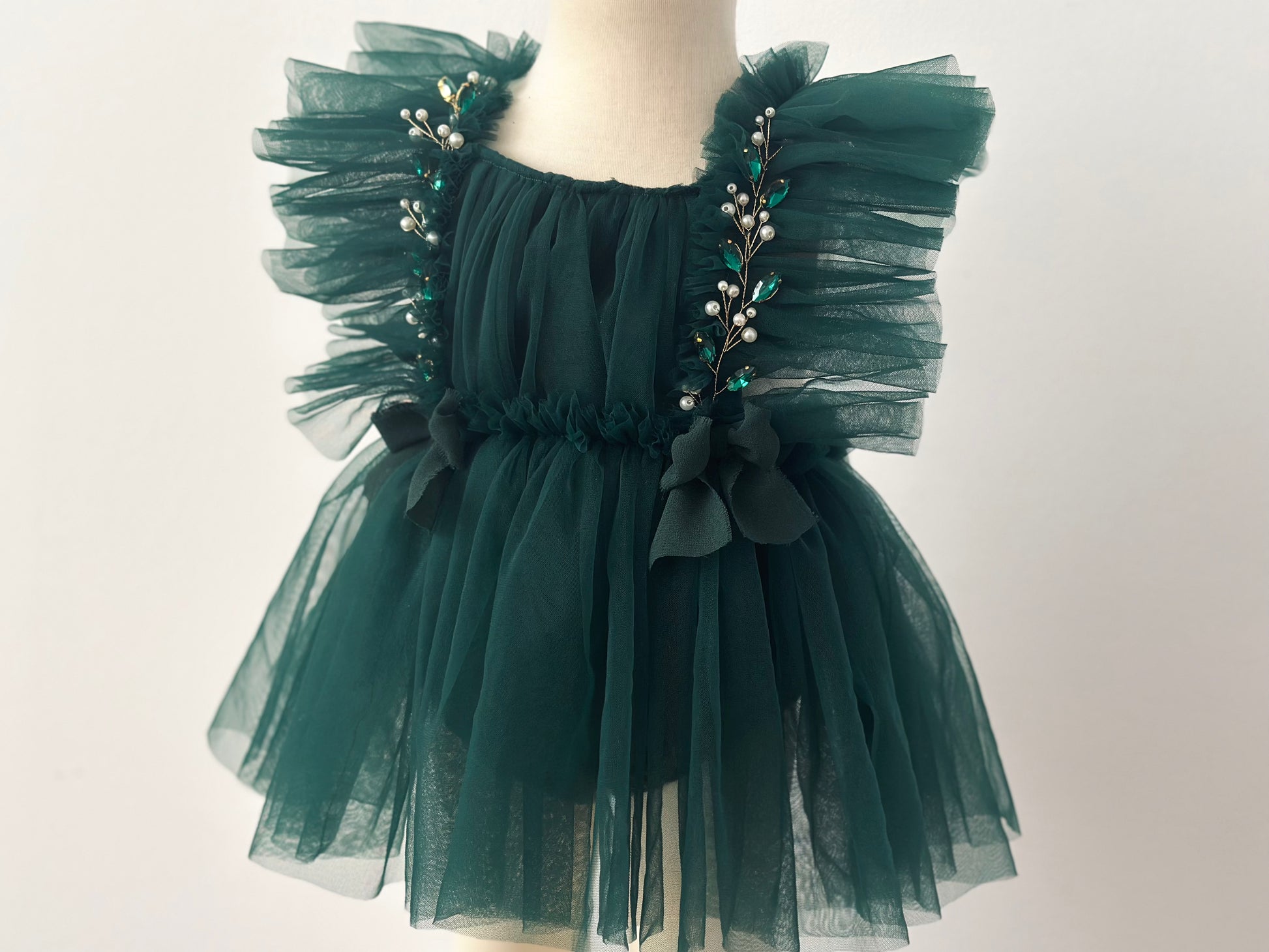 Evergreen girl dress photoshoot Christmas session with ruffled tulle and pearl embellishments by FLEUR MARGOT