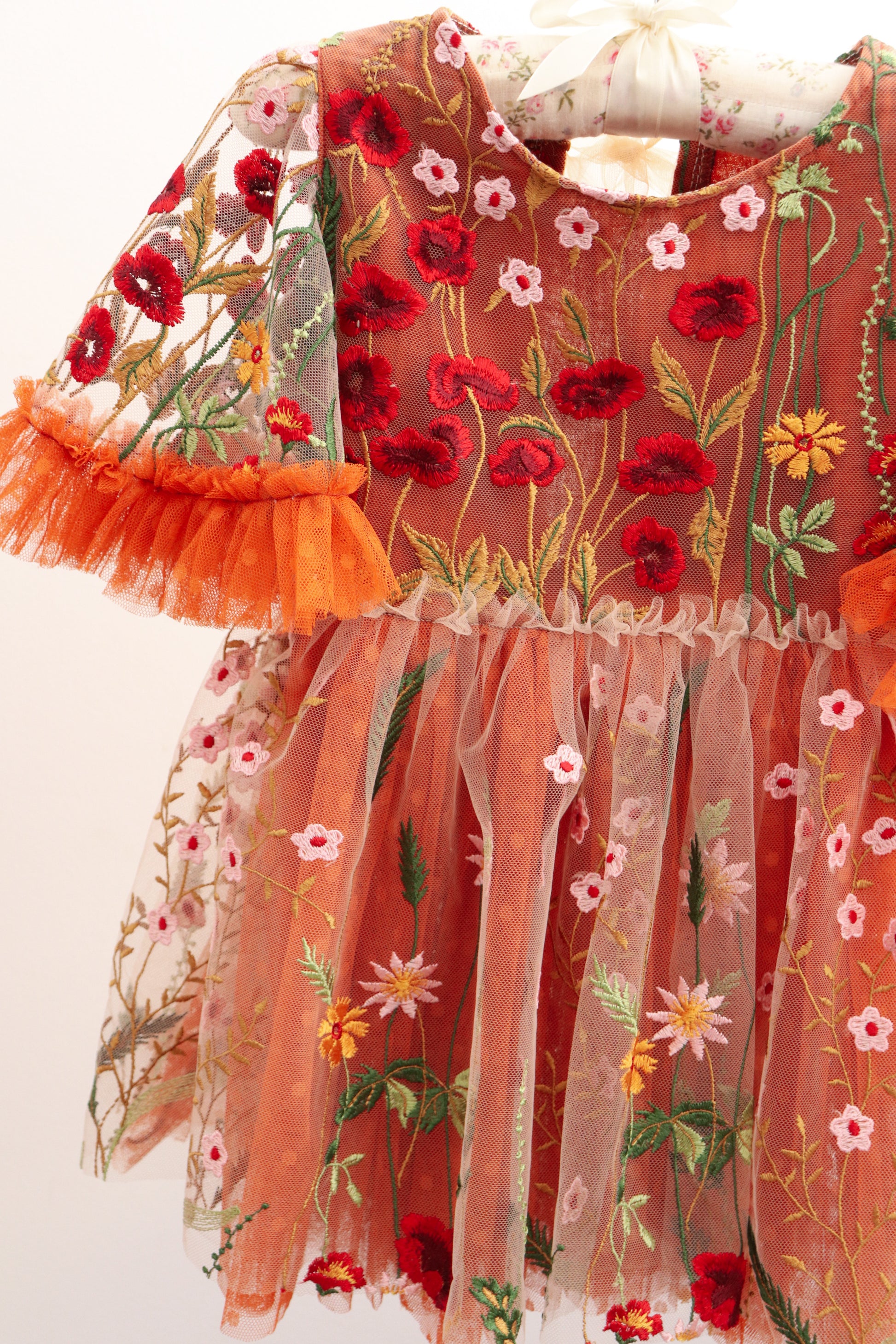 Girl embroidered photo prop dress with red and pink floral designs and sheer orange tulle skirt