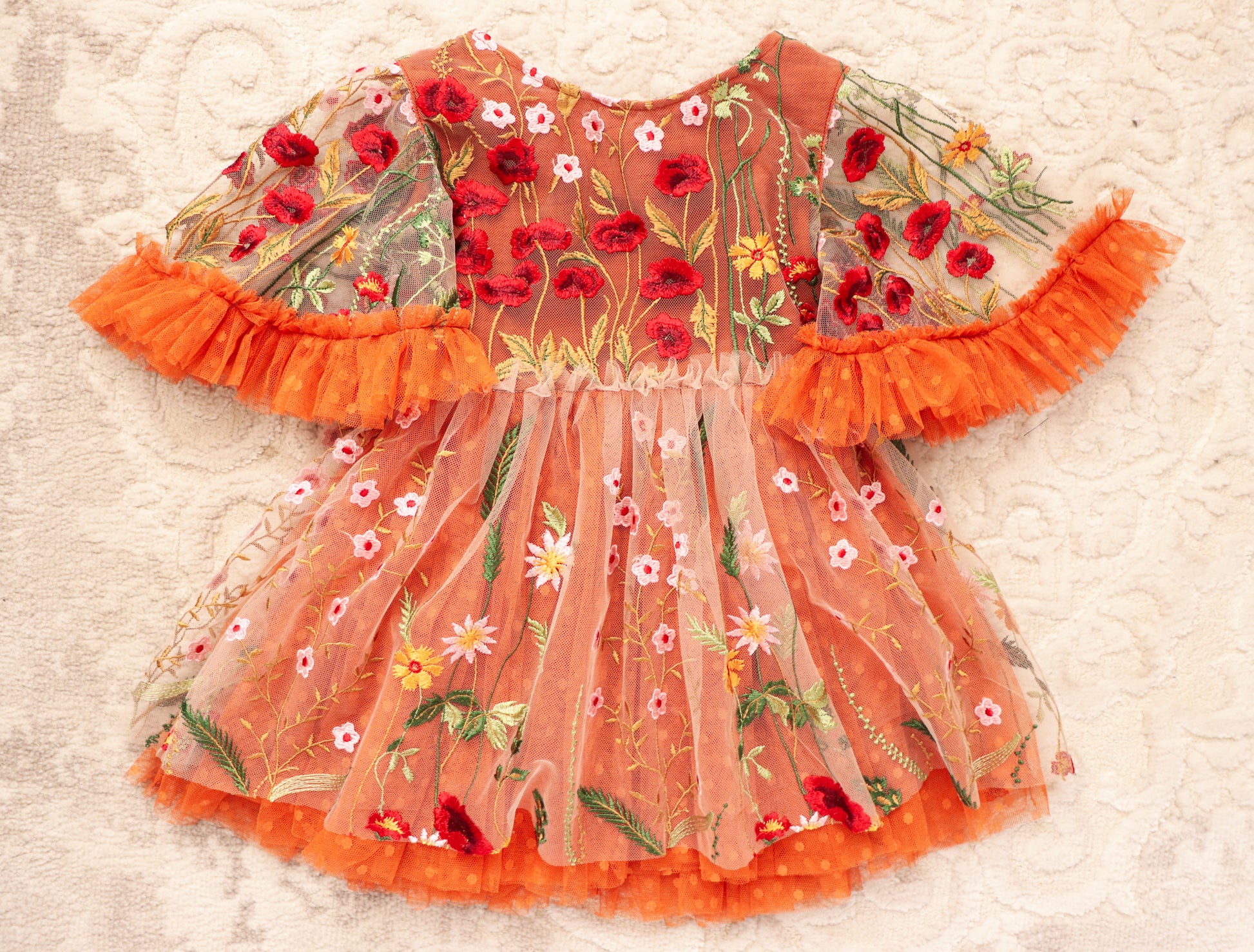 Girl embroidered photo prop dress with floral designs and orange ruffle sleeves by FLEUR MARGOT
