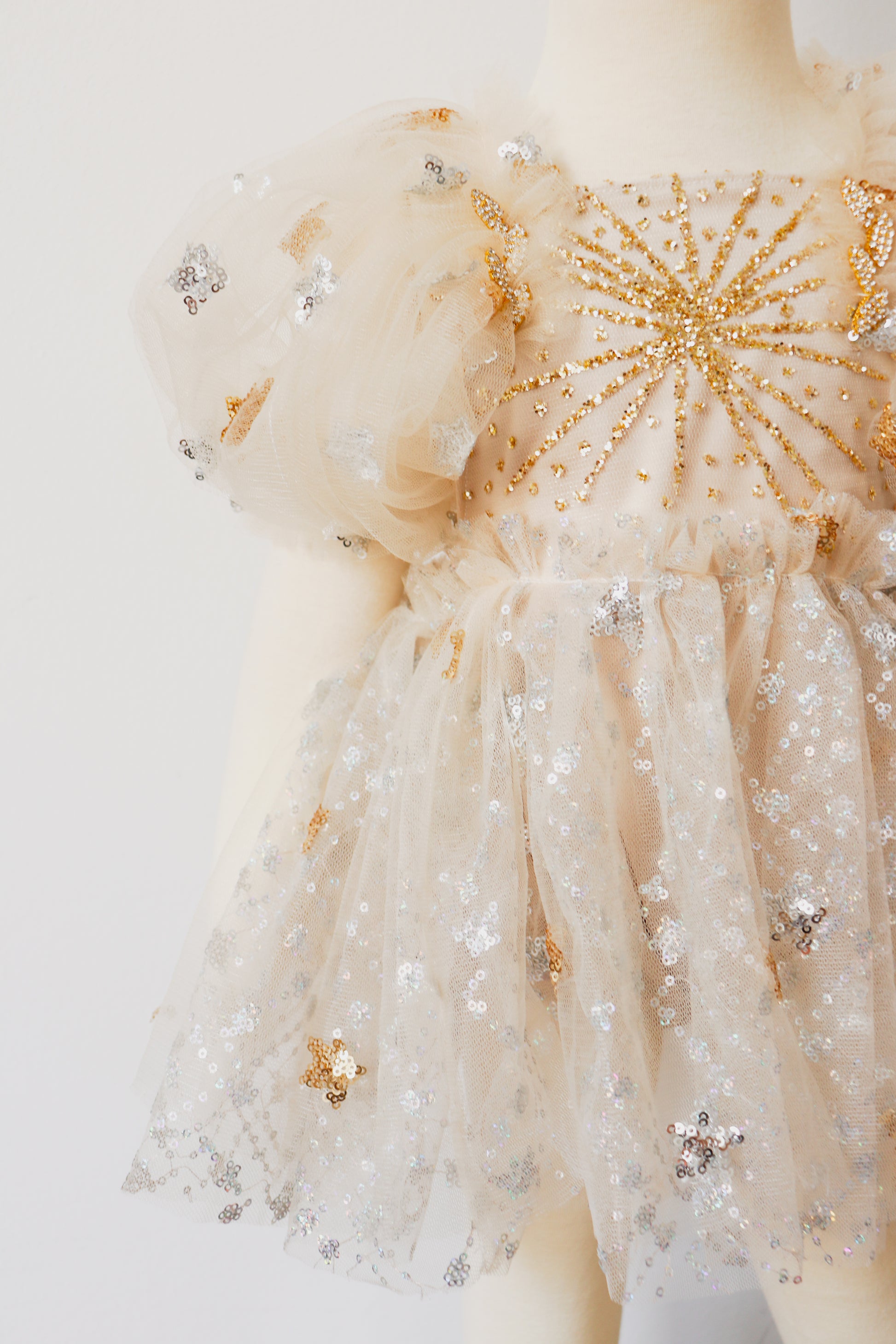 FLEUR MARGOT gold sequin baby dress with puff sleeves and star-patterned tulle overlay