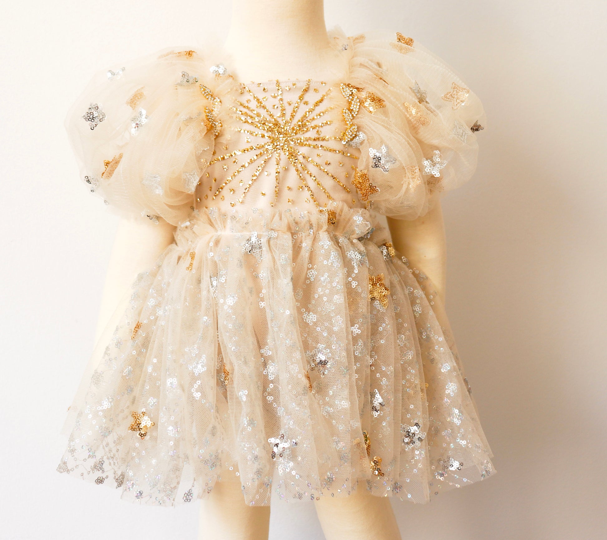 FLEUR MARGOT gold sequin baby dress with puffy sleeves and star embellishments on tulle fabric