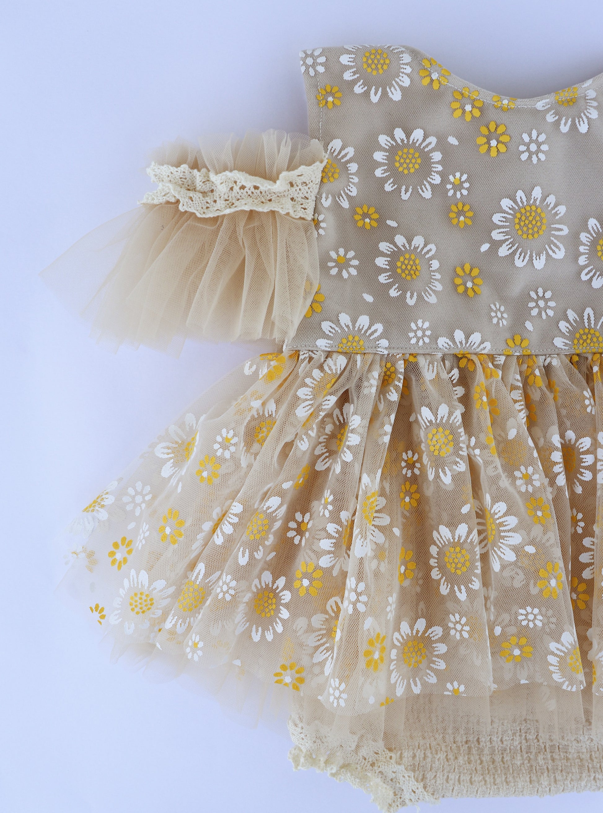 Handmade daisy baby dress with yellow and white floral pattern and lace tulle sleeves by FLEUR MARGOT