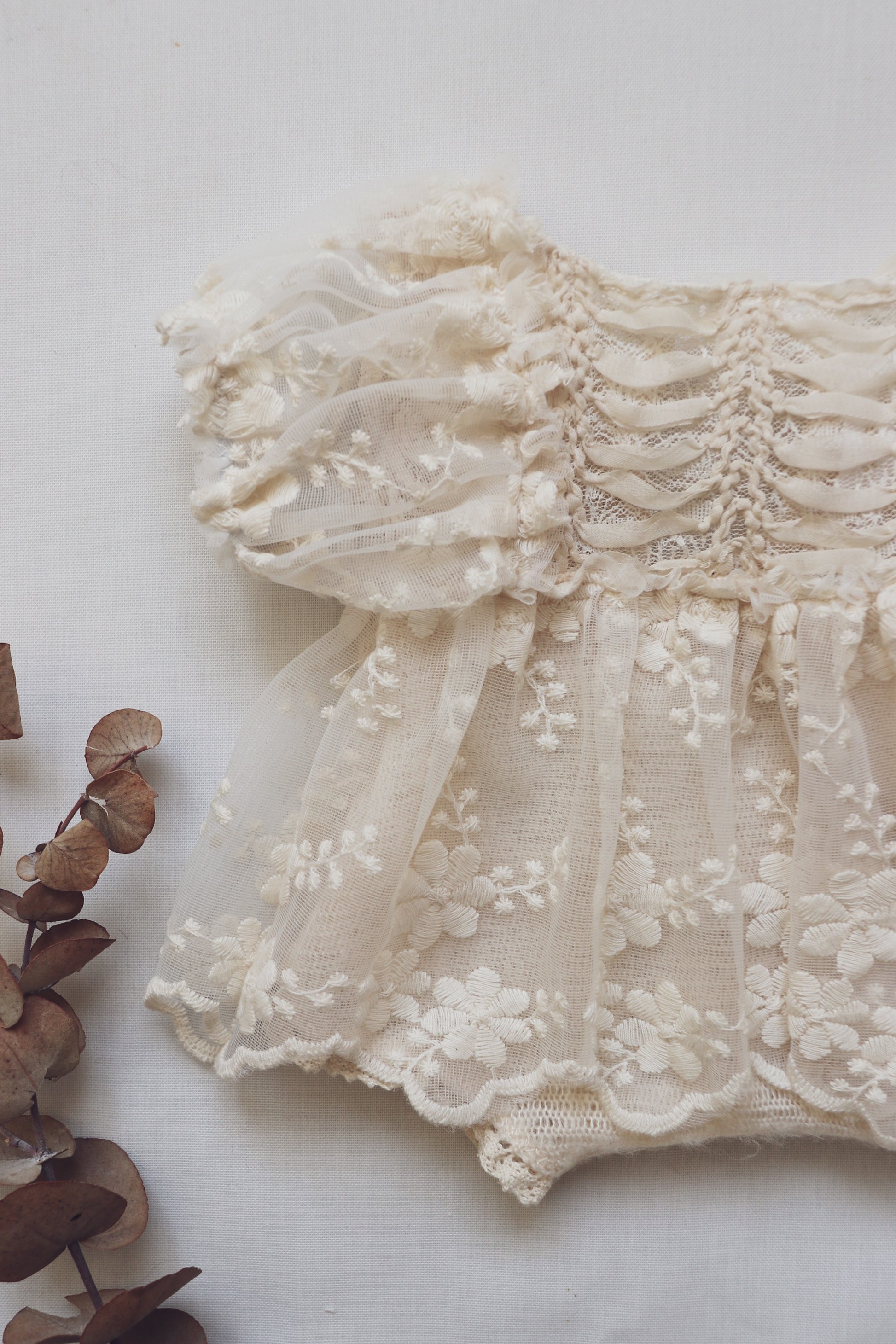 Cream lace newborn photo outfit with floral embroidery and puff sleeves from FLEUR MARGOT