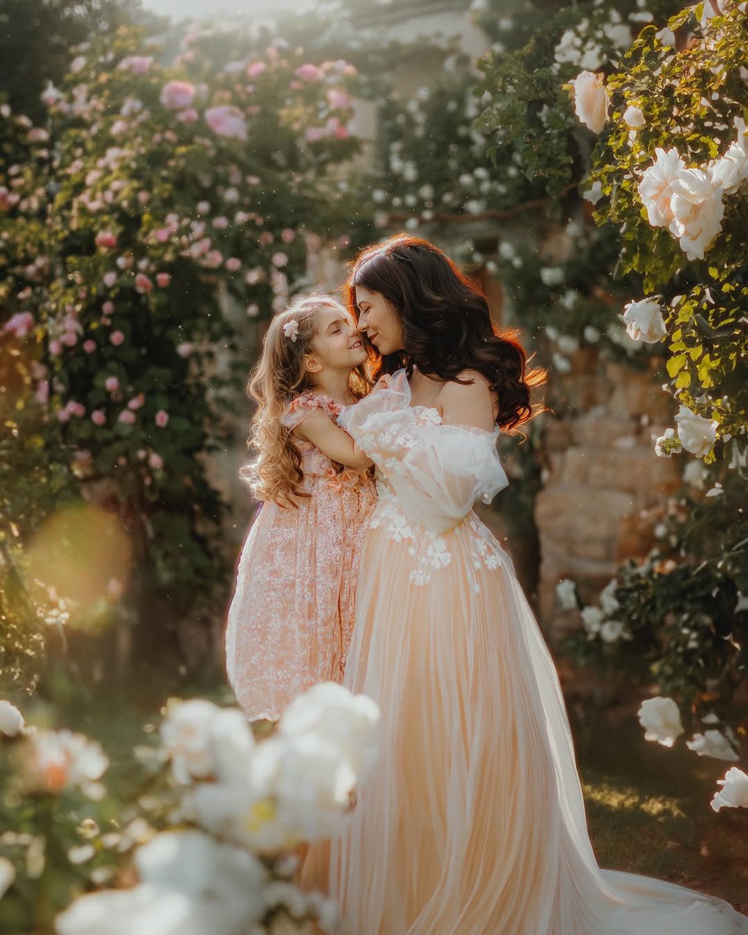 Mother and daughter in garden with daughter wearing a pink sitter session dress pink by FLEUR MARGOT