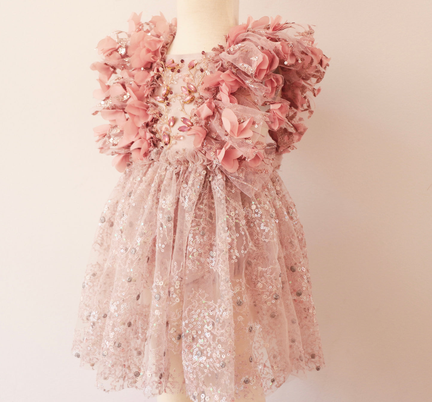 Princess-style flower girl dress with shimmering pink sequins, silver embroidery, and delicate floral accents."
