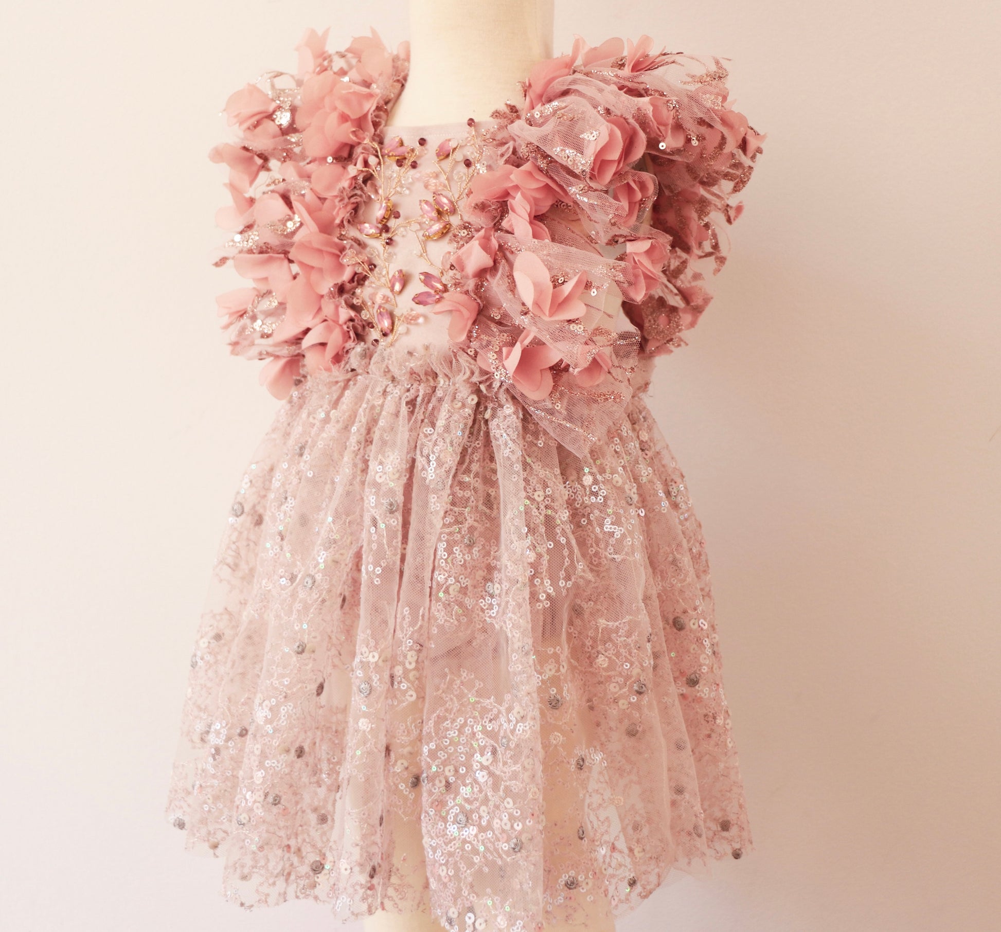 Princess-style flower girl dress with shimmering pink sequins, silver embroidery, and delicate floral accents."
