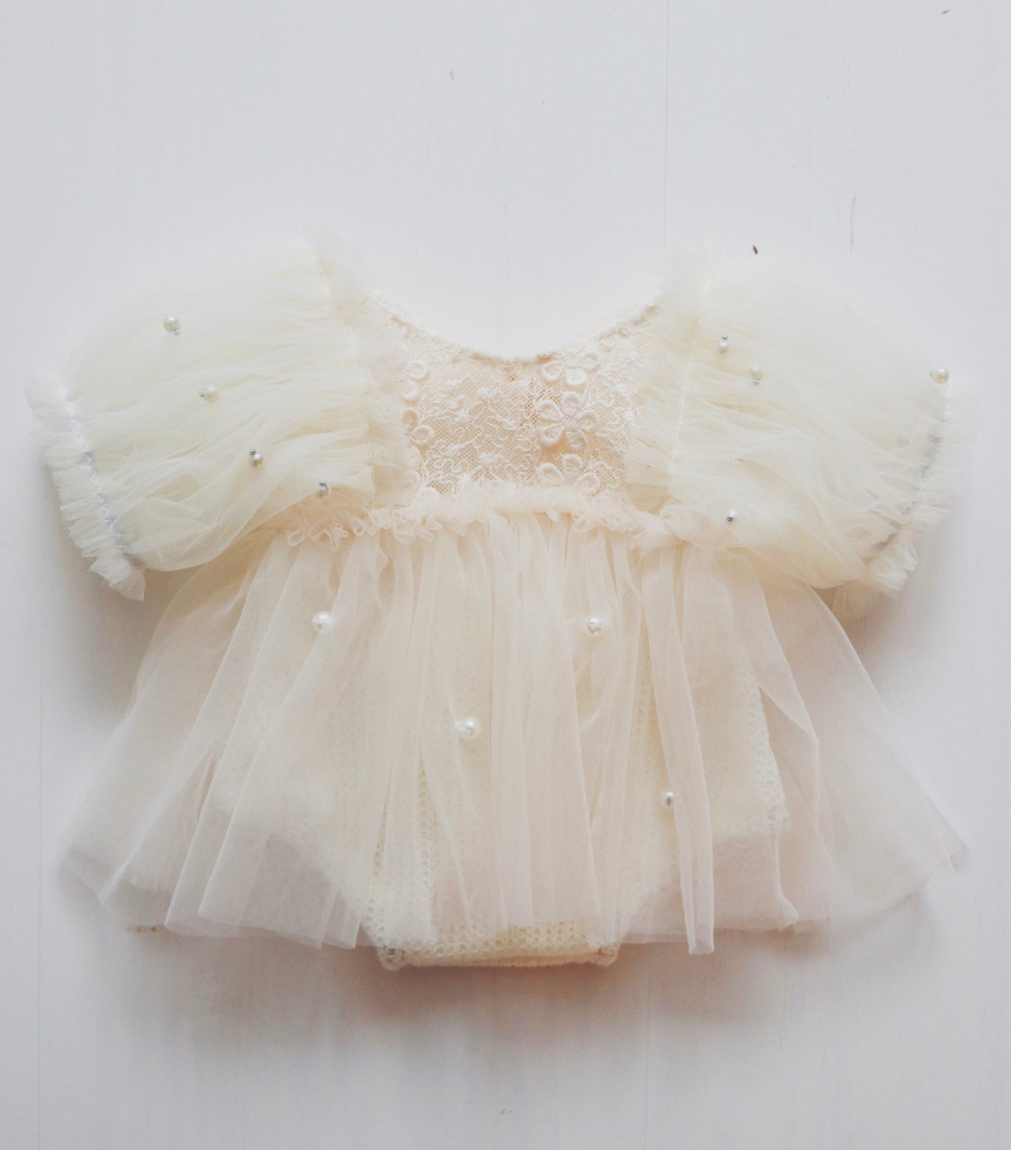 Newborn girl’s romper dress with puffy ivory tulle sleeves, beige 3D embroidered flowers on bodice, and soft wool pantie