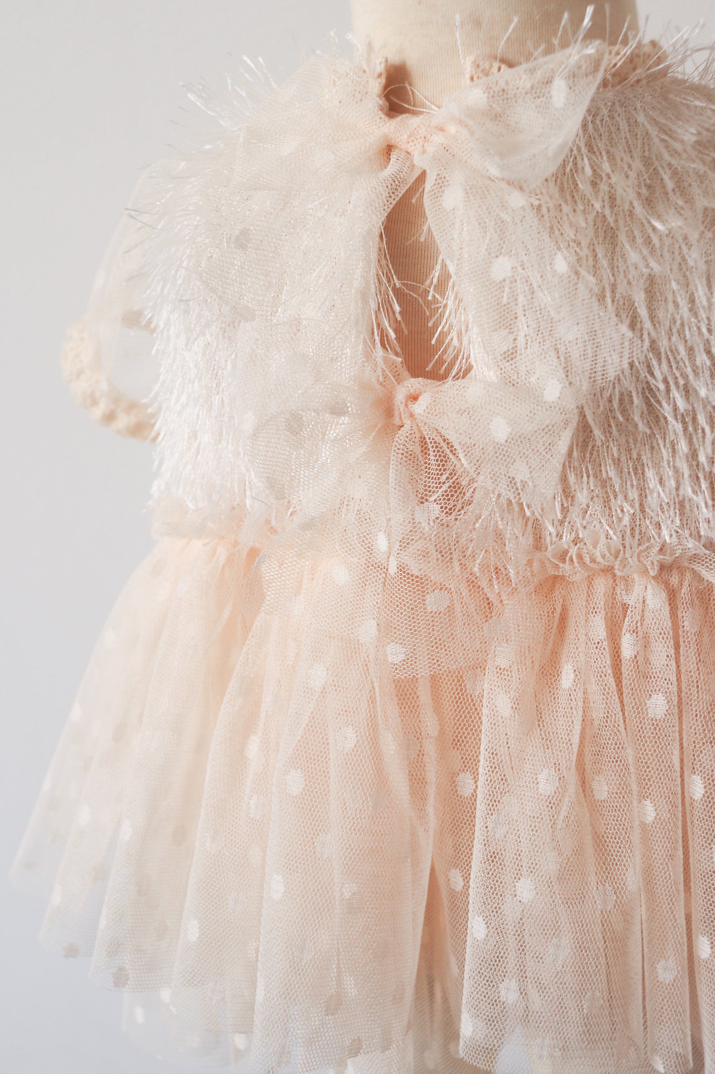 Girl’s two-piece dress with ivory fringe bodice, dotted tulle sleeves, and beige dotted skirt – perfect for special occasions