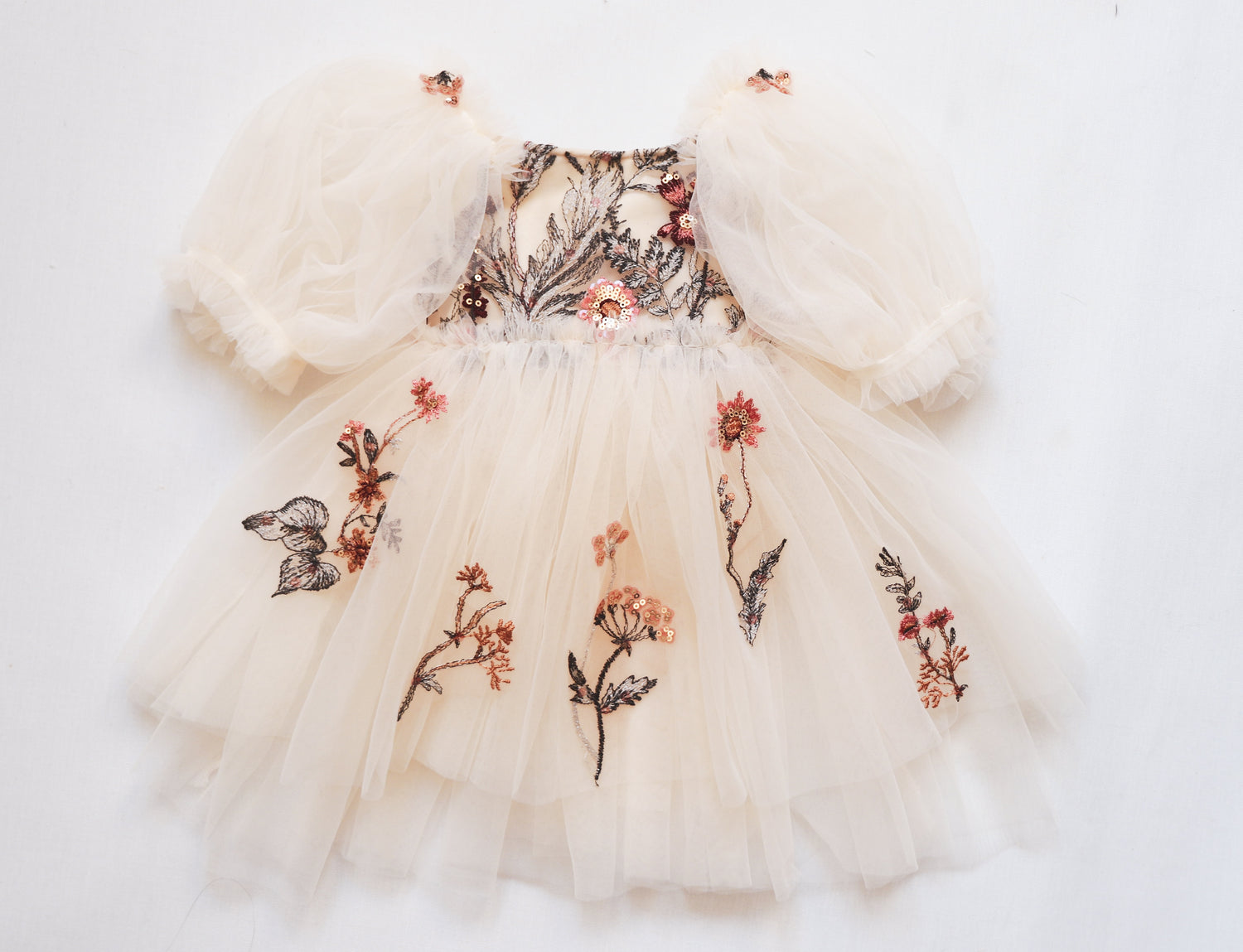 Beautiful special occasion dress for girls with an ivory velvet bodice and floral embroidered skirt."