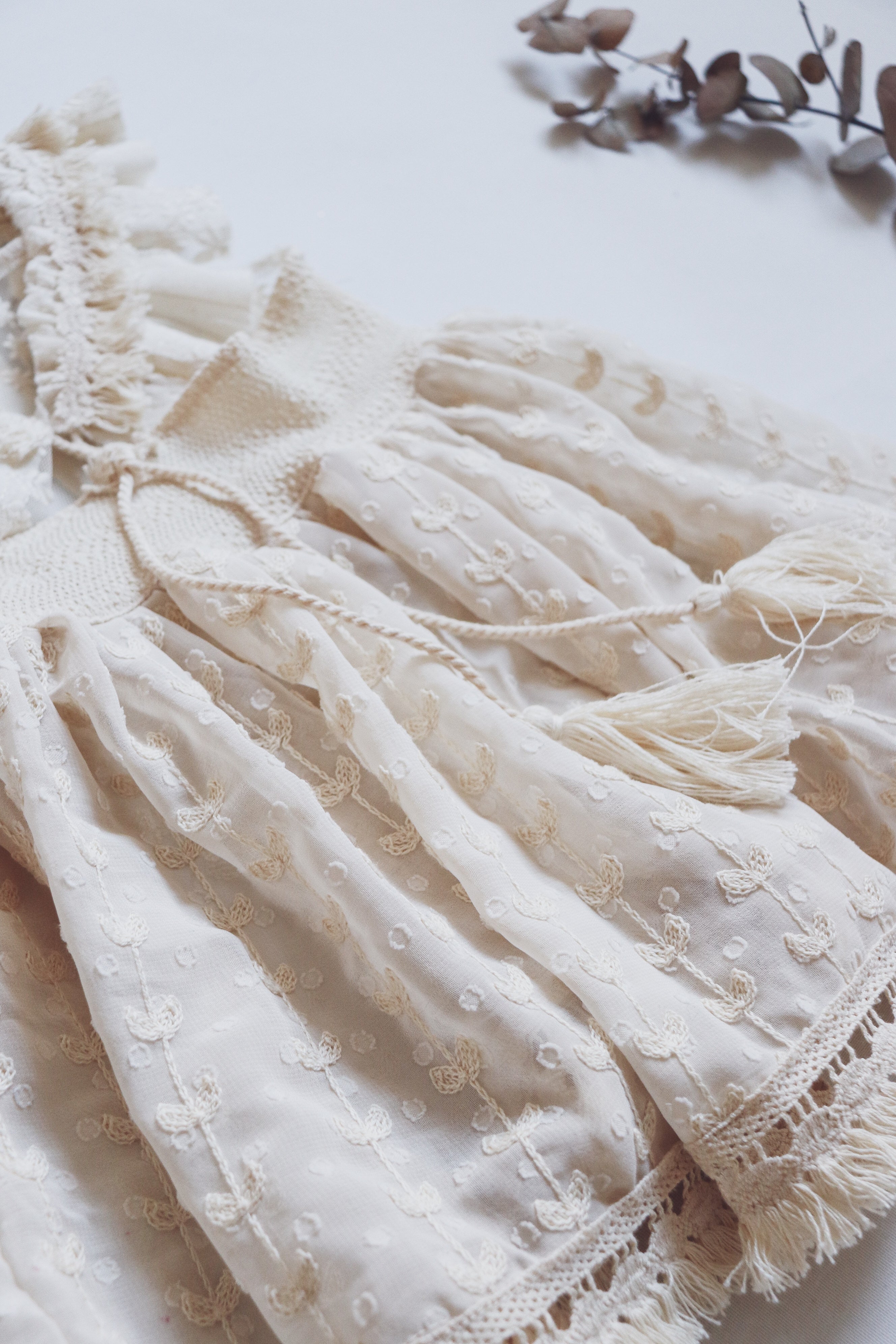 Vintage-inspired boho dress with embroidered lace, chiffon heart skirt, and soft fringe straps, perfect for photoshoots