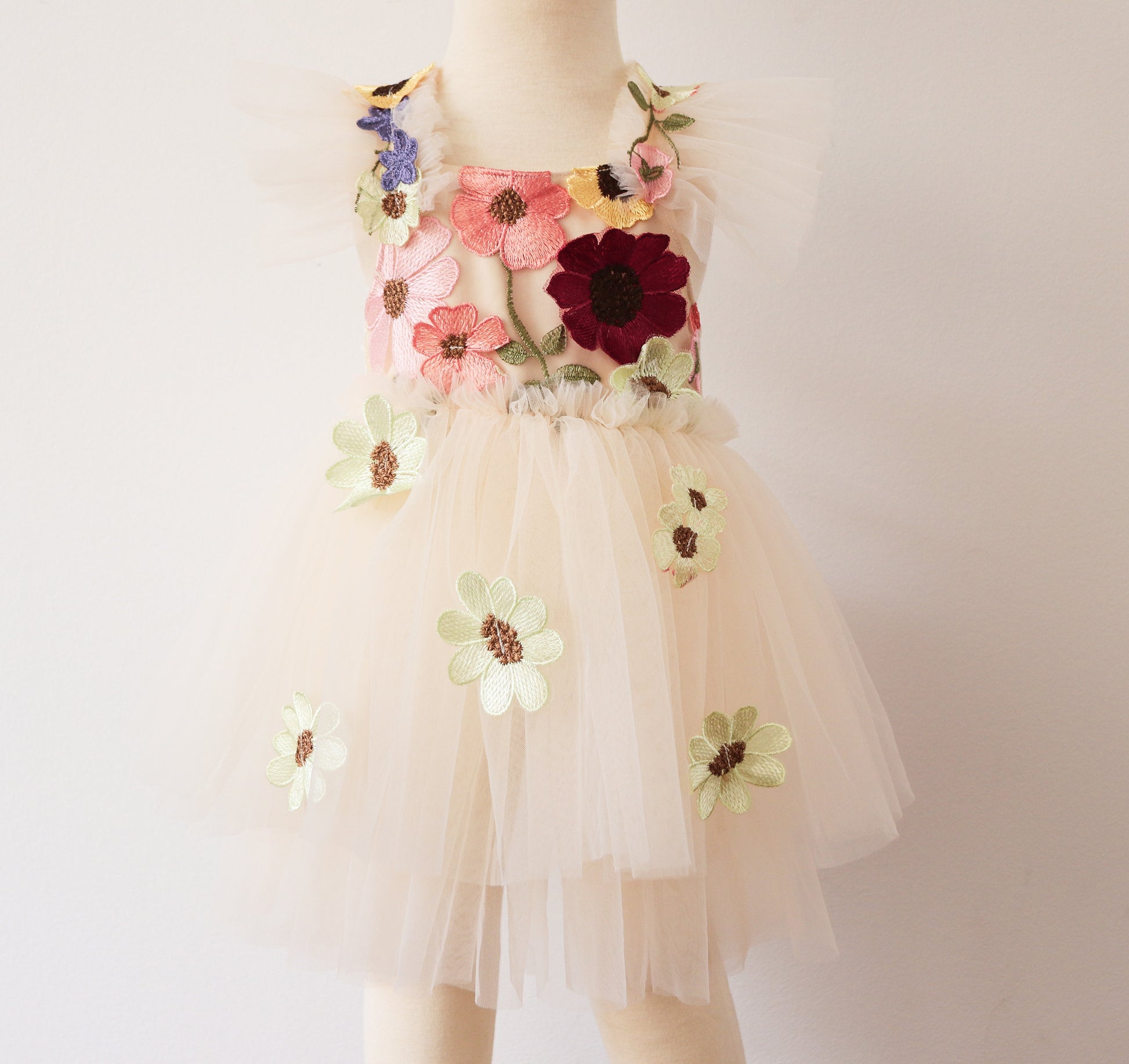 Elegant girl’s dress featuring a beige velvet bodice with floral embroidery, a double-layered ivory tulle skirt, and 3D embroidered flowers, perfect for spring photoshoots and birthday celebrations