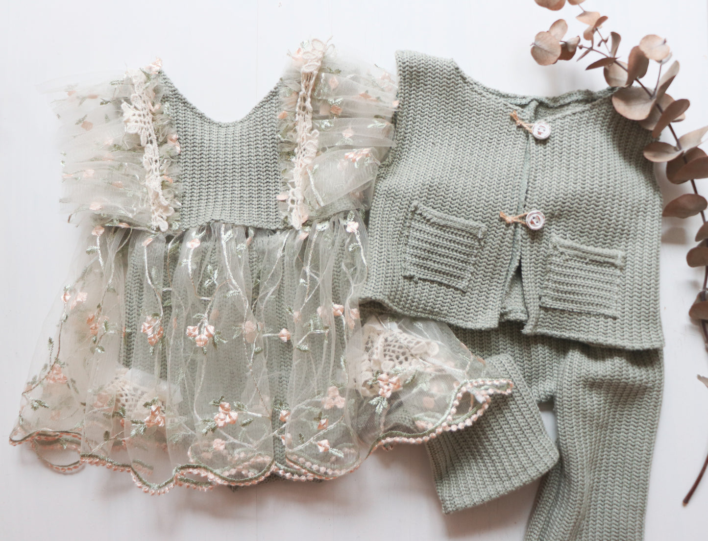 Designed for sitter-size baby boys, this outfit set combines comfort and elegance. The sage green vest and matching pants are crafted from soft, cozy wool with charming details like wooden buttons and small pockets, making it an ideal choice for photoshoots and celebrations."

