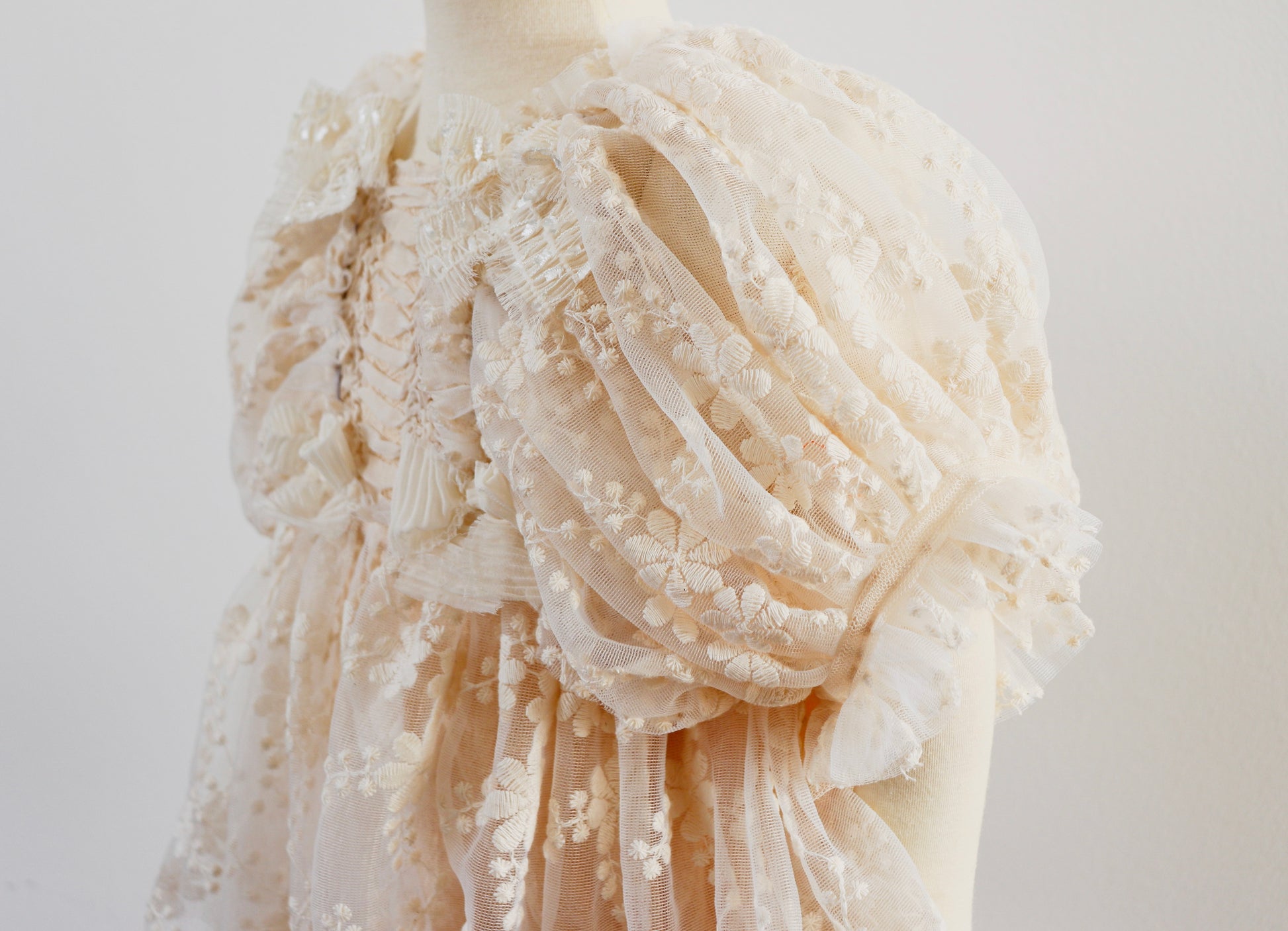 "Girl twirling in a vintage-inspired dress with beige embroidery and lace, perfect for rustic boho photography moments."


