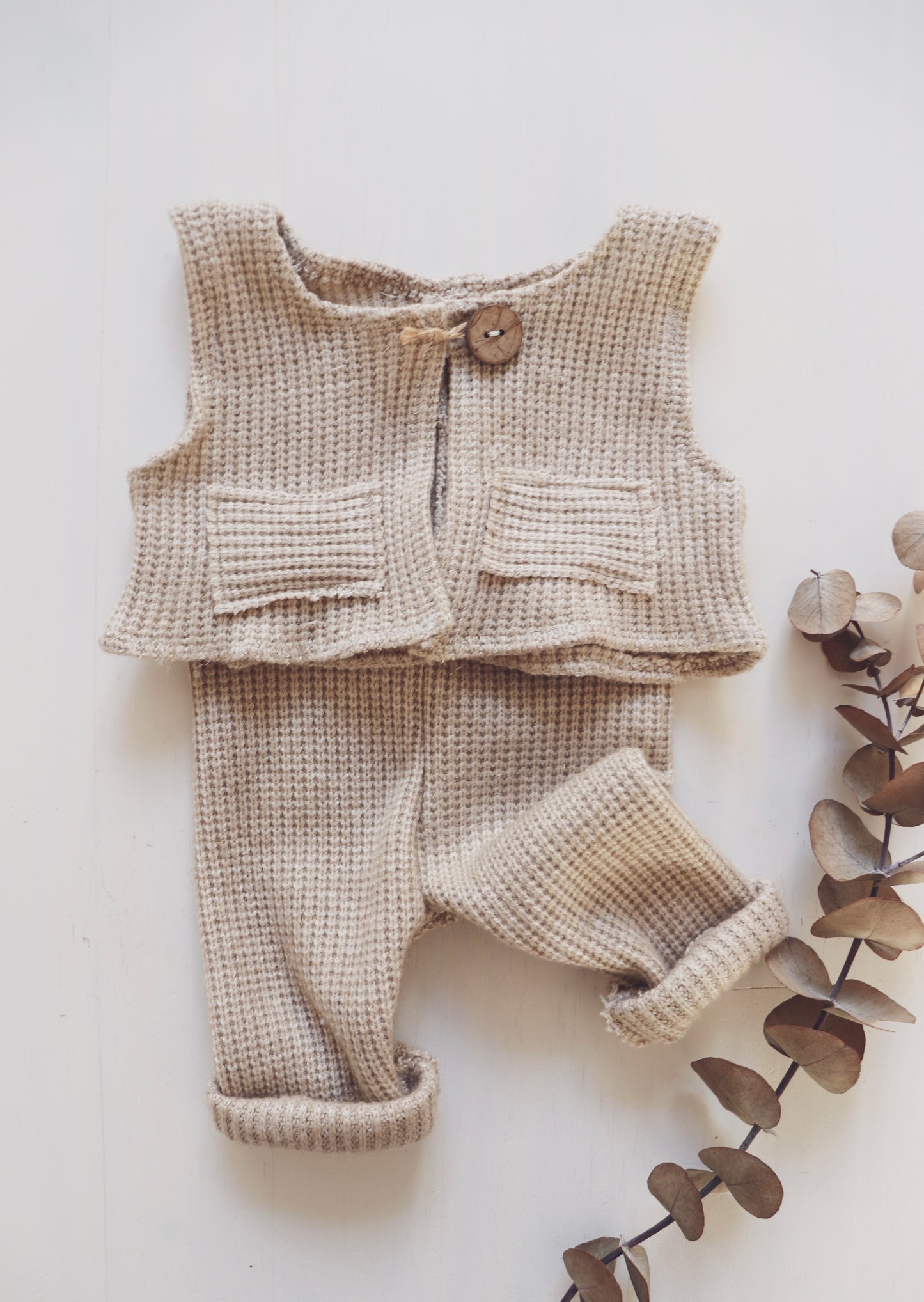 Newborn boy’s outfit set with light brown soft wool collar, beige vest with wooden buttons, and matching pants – perfect for photoshoots