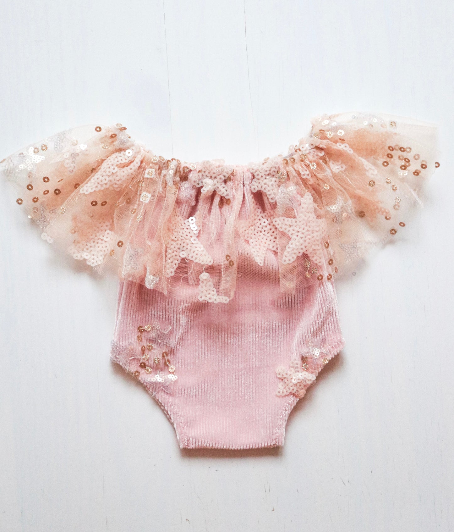 oft baby pink newborn romper with a ruffled neck and star-shaped sequins, ideal for photoshoots