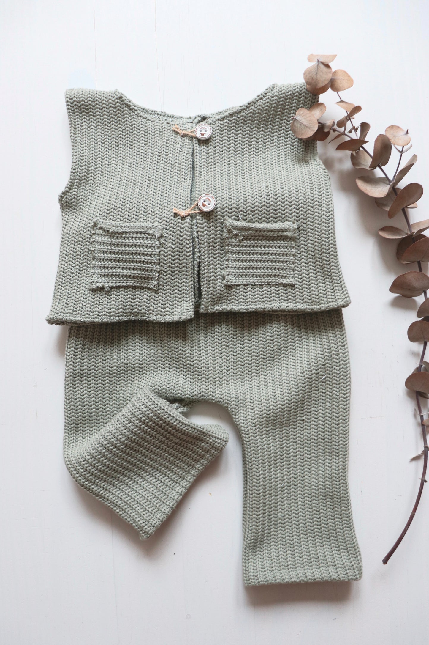 Capture timeless moments with this adorable boy’s sitter-size outfit set. Featuring a sage green wool vest with small pockets and wooden buttons, paired with matching pants, this set is perfect for milestone photoshoots or special occasions. The soft wool fabric ensures comfort while exuding a rustic charm