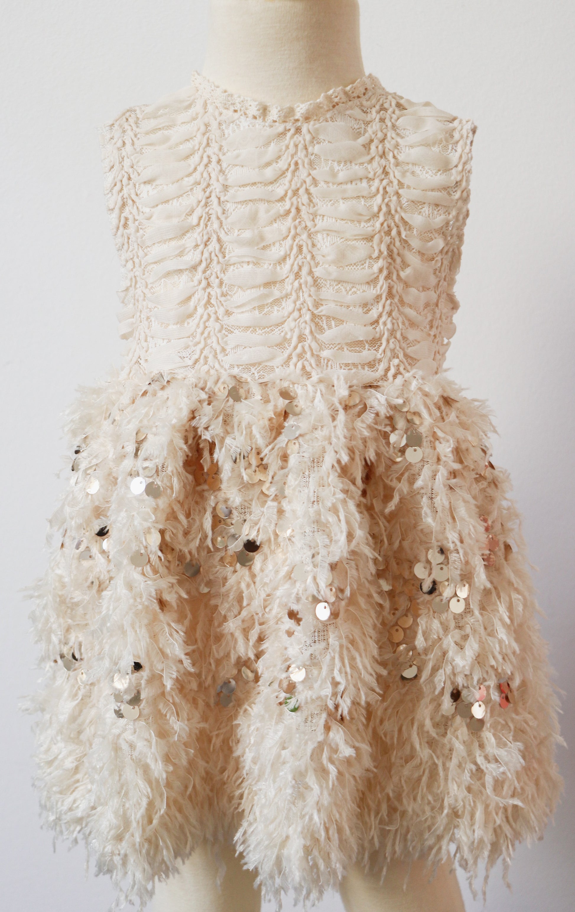 Perfect for formal occasions, this light beige dress offers a chic Rococo style with a feathered skirt and elegant pearl buttons