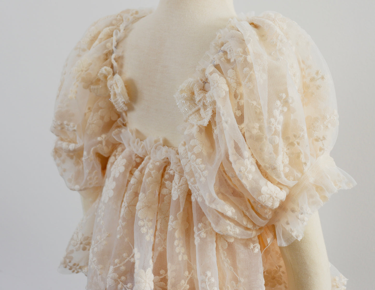 "Boho-style girl dress with delicate lace details and puffy sleeves, styled for a dreamy countryside photo session."

