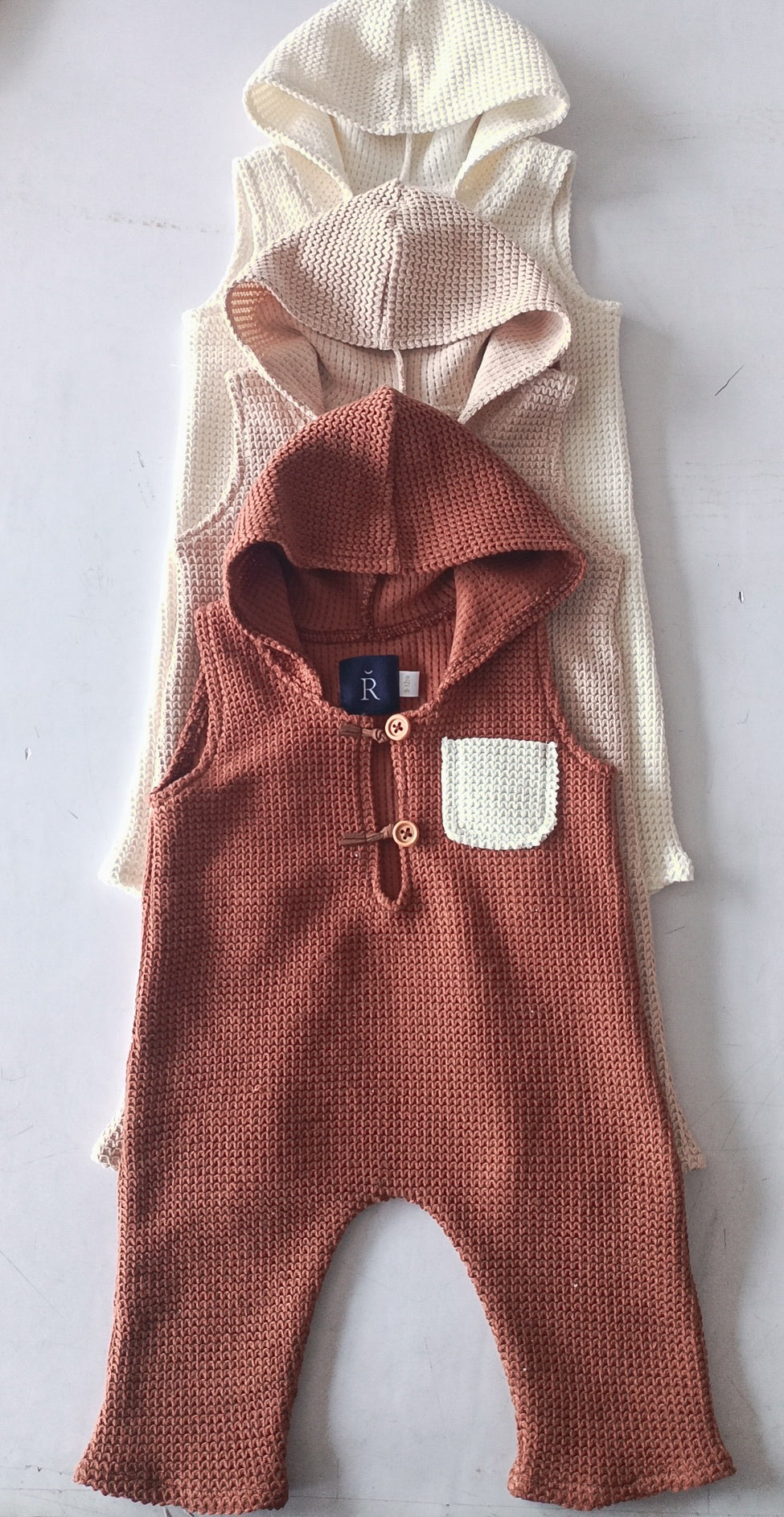 RBYFLEURMARGOT sitter romper for photoshoot in brown with hood and front pocket with buttons