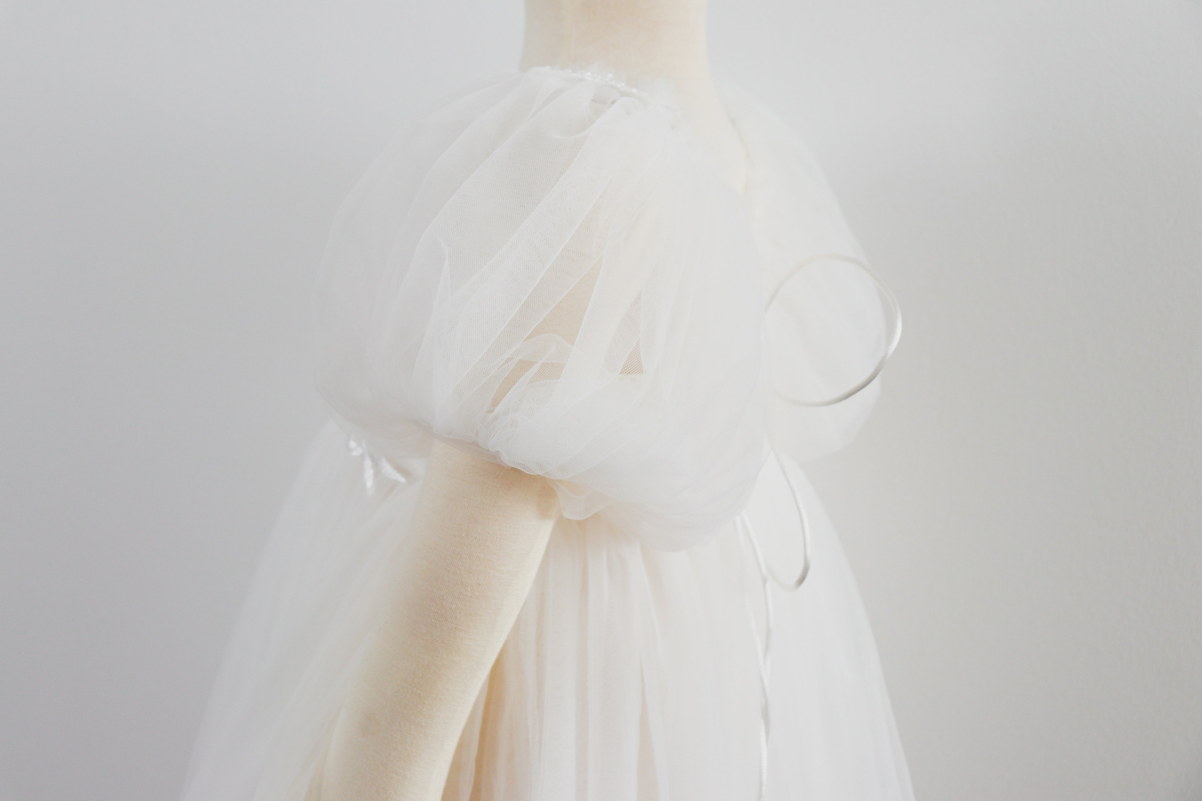White delicate girl photo shoot dress with puff sleeves and sheer fabric by FLEUR MARGOT