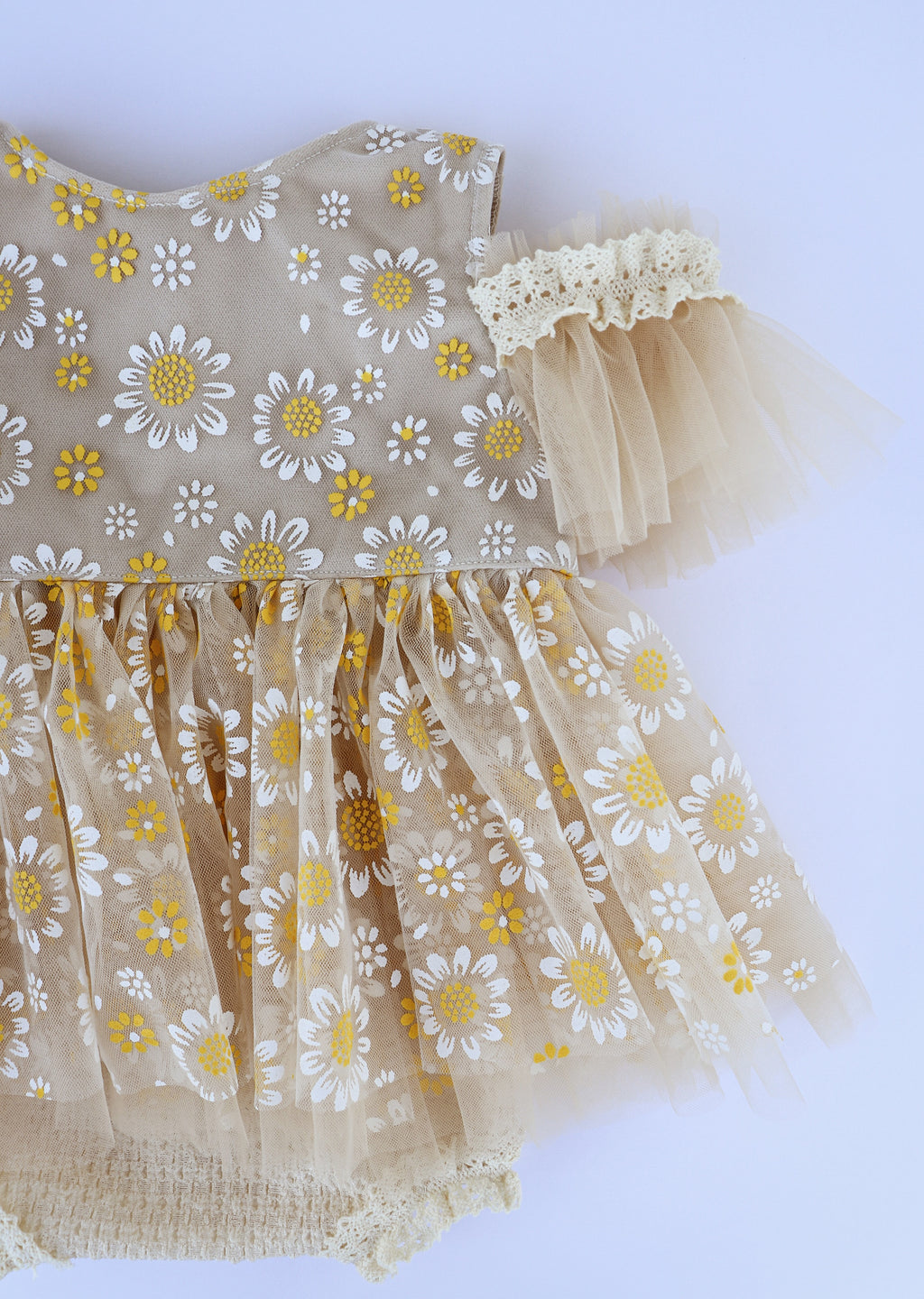 Handmade daisy baby dress by FLEUR MARGOT featuring beige fabric with white and yellow daisies and tulle sleeves