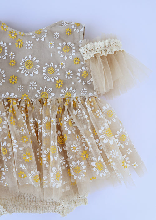 Handmade daisy baby dress by FLEUR MARGOT featuring beige fabric with white and yellow daisies and tulle sleeves