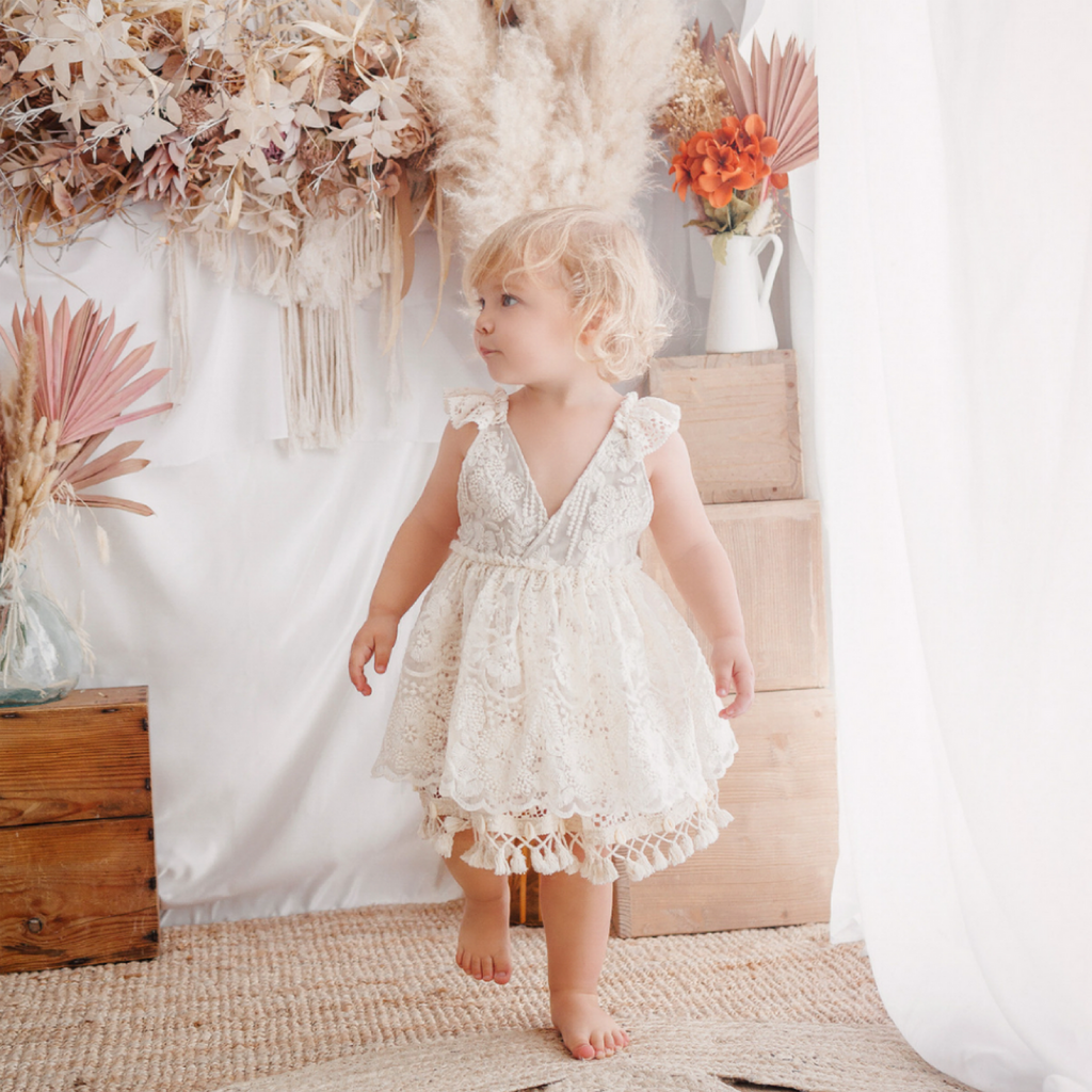Adorable girl’s dress with shell fringe trim, ideal for beach and boho-themed photo sessions